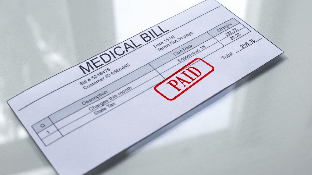 A medical bill marked as paid thanks to Colorado personal injury law that allows people to get compensated fully for their injuries do to accidents where they are not at fault.