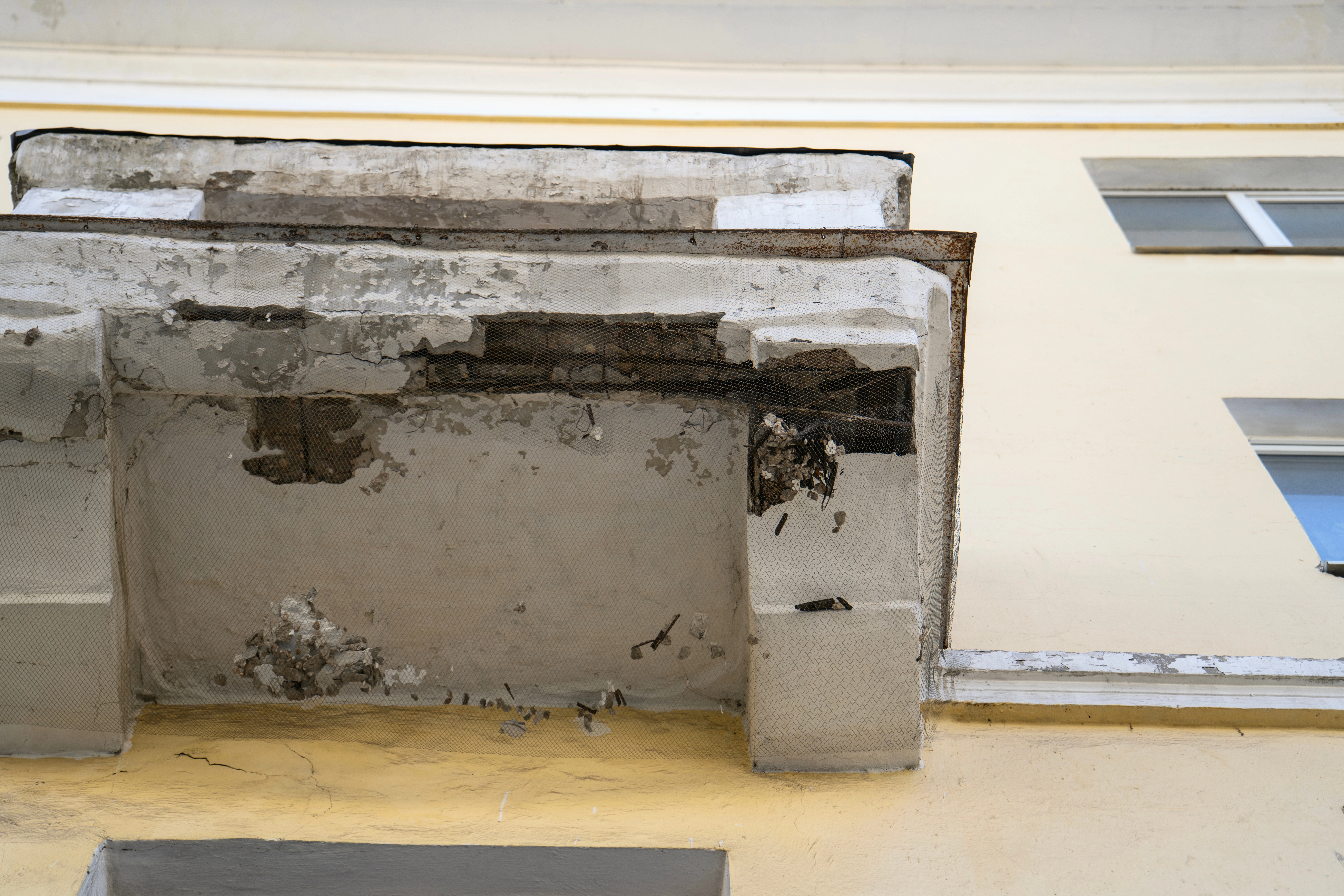 A damaged balcony showing water staining and rot, a liability risk that construction defect attorneys can help resolve.