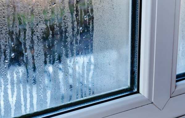 Significant vertical and horizontal cracking in a party wall with peeling plaster, a common structural failure investigated by condo construction defect attorneys.