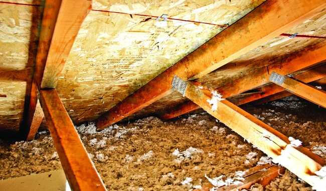 Worker inspecting a clogged or failing storm drain system at a residential complex, a common infrastructure issue litigated by townhome construction defect attorneys.