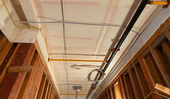 Significant vertical and horizontal cracking in a party wall with peeling plaster, a common structural failure investigated by condo construction defect attorneys.