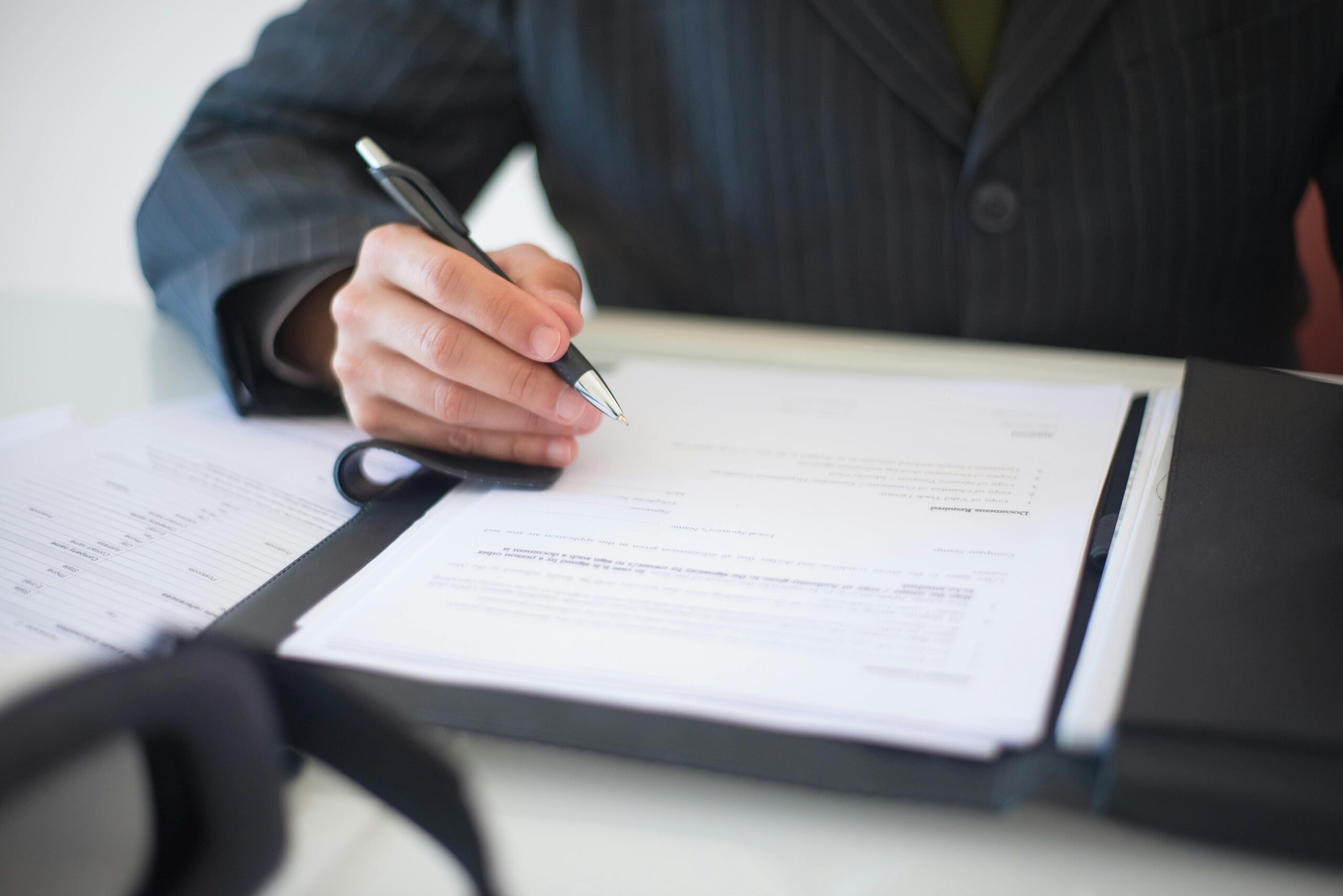 pexels-kampus-8815849 (1) Employee reviewing a severance agreement document during a legal consultation, representing employment separation terms and legal guidance from a Colorado severance agreement attorney.