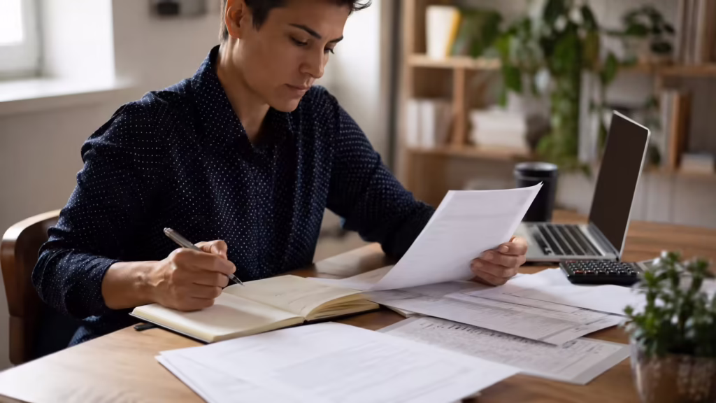 Colorado employee reviewing pay stubs and wage records while evaluating an unpaid wages claim